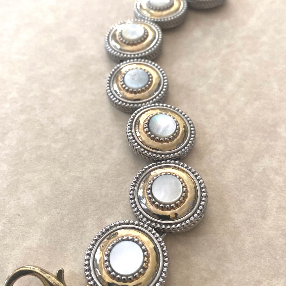 Silver and gold round link bracelet with mother of pearl inlays.